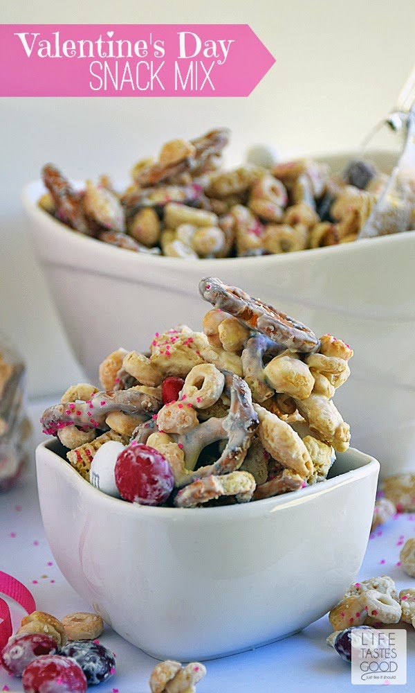 Valentine's Day Snack Mix is a delicious way to share the love with all of your favorite Valentines. This sweet snack mix is made with M&M's® Red Velvet candies, crispy cereal, crunchy pretzels, and salty peanuts all covered in creamilicious white chocolate and sparkly pink sprinkles! #RedVelvetLove #ad