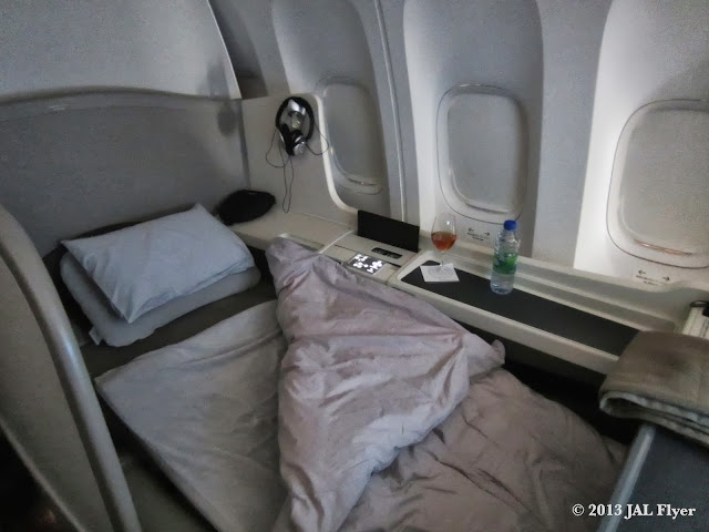 JAL First Class trip report on JL005 - Turndown service with Tempur mattress and down comforter