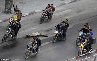 Palestinians drag body of suspected spy behind motorcycles in Gaza Palestinians drag body of suspected spy behind motorcycles in Gaza
