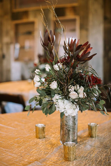 Wedding centerpieces in mercury glass containers