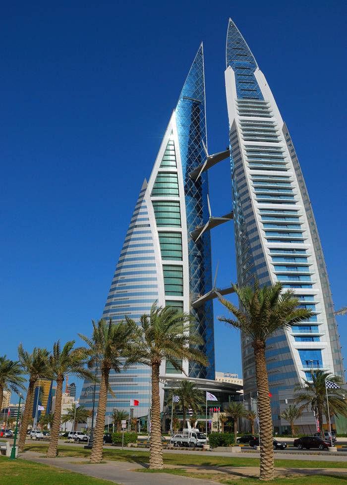 The Bahrain World Trade Center is a 240 m (787 ft) high twin tower complex located in Manama, Bahrain. The towers were built in 2008 by the multi-national architectural firm Atkins. It is the first skyscraper in the world to integrate wind turbines into its design. The wind turbines were developed, built and installed by Danish company Norwin A/S. This 50-floor structure is constructed in close proximity to the King Faisal Highway, near popular landmarks such as the towers of BFH, NBB and Abraj Al Lulu.