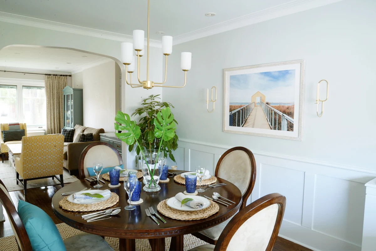 Rambling Renovators | tropical dining room, round dining table, Hinkley Harlow chandelier, blue and rattan