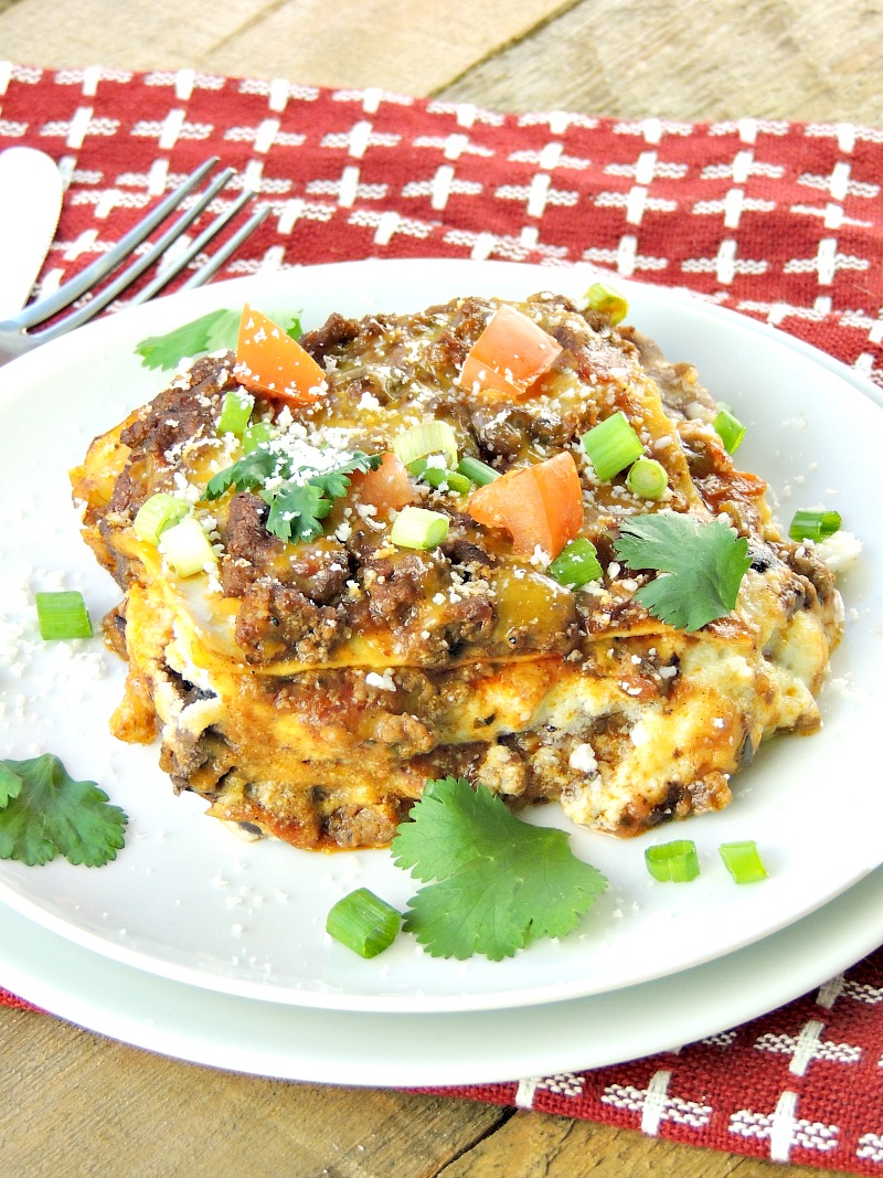 Serving of Mexican Lasagna on a white plate.