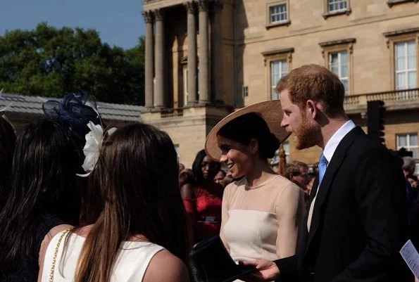 Meghan Markle wore Goat Fashion Flavia Dress, and Tamara Mellon 'Siren' blush nappa leather pumps, she carried Wilbur and Gussie bespoke silk clutch