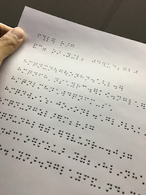 a page showing braille printed in ink