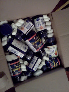 Newly opened box filled with nutritional supplements and packing peanuts