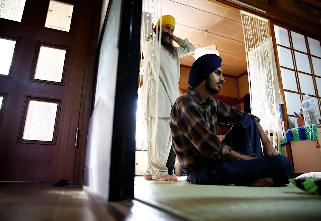 Image Attribute: Gursewak Singh (R) and his father Bharpoor Singh are seen in the living room of their house during an interview with Reuters in Matsudo, Japan, September 25, 2016. REUTERS/Kim Kyung-Hoon
