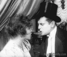 A man and a woman in a silent film arguing