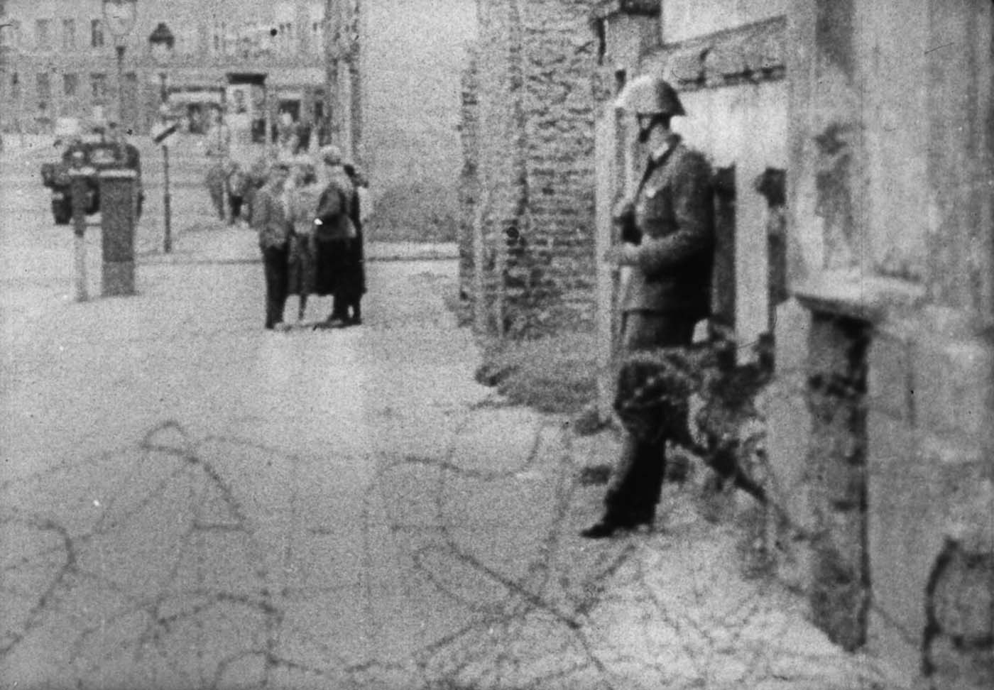 Conrad Schumann preparing himself to jump to the West side. (Still from the footage).