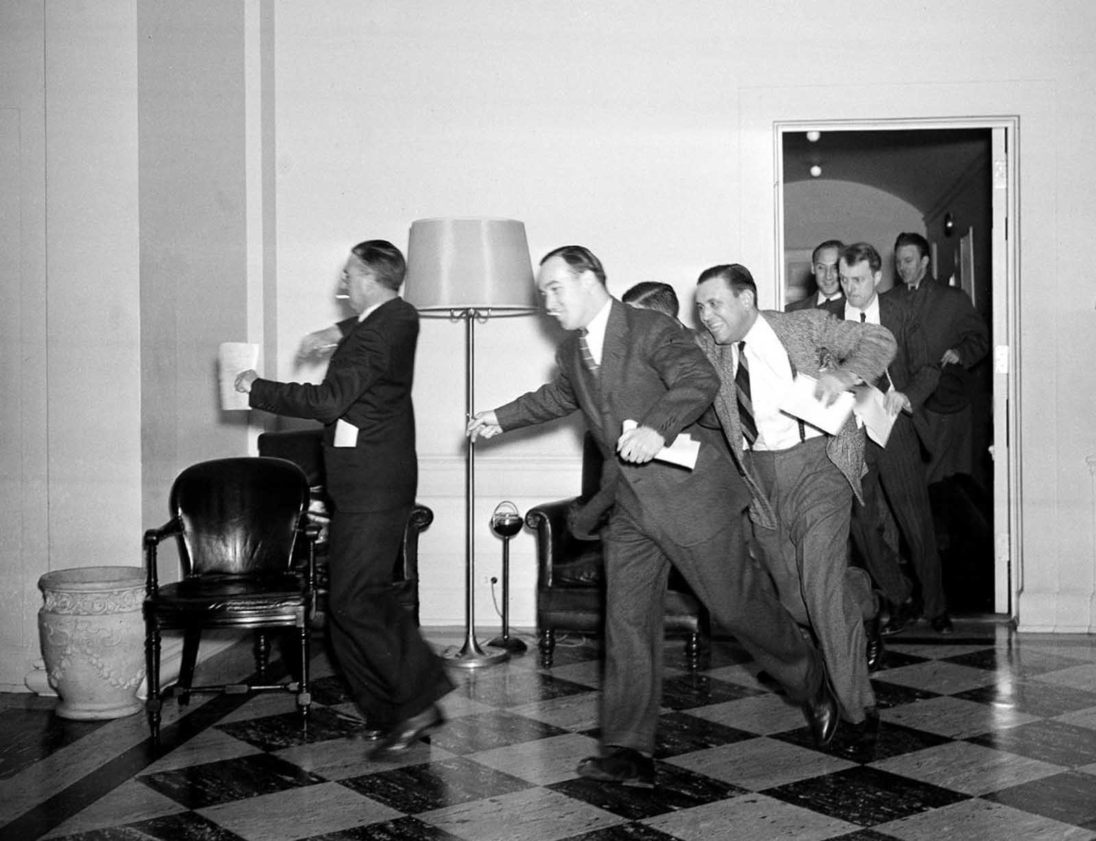 White House reporters dash for the telephones on December 7, 1941, after they had been told by presidential press secretary Stephen T. Early that Japanese submarines and planes had just bombed the U.S. Pacific fleet at Pearl Harbor, Hawaii.