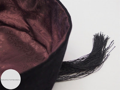 Men's classic 19th century style black velvet smoking cap with tassels and burgundy paisley silk lining.