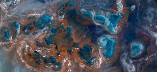 blue islands on orange red background sand,iridescent turquoise blue stars together to form a galaxy, abstract landscapes of deserts of Africa from the air, Munimara Collection of Abstract Naturalism blue islands on orange red background sand,iridescent turquoise blue stars together to form a galaxy, abstract landscapes of deserts of Africa from the air,
