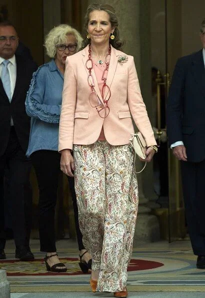 Infanta Elena of Spain wore Boss pumps and Mango pink jacket and Zara print trousers carried Mango clutch