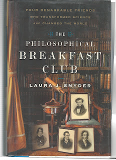 Book cover The Philosophical Breakfast Club by Laura J. Snyder picture shows bookshelf and open curtains with photographs of four yound men in 19th century dress
