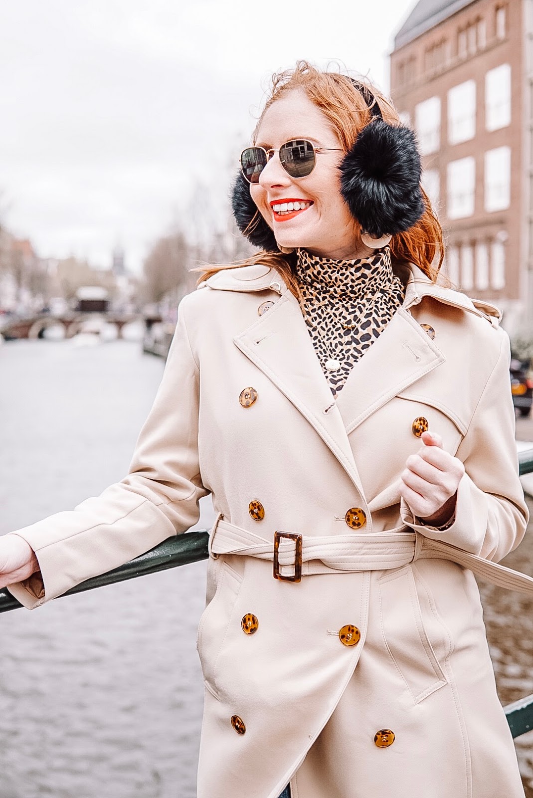 amanda burrows is a tampa blogger traveling to amsterdam in the spring. she is wearing a tan trench coat from h&m.