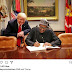 Photo of President Buhari signing a document beside President Trump