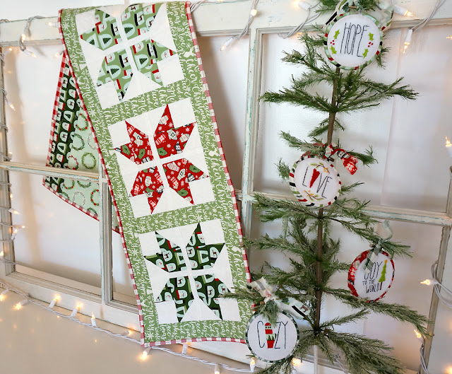 Joyful Snowflake table runner is sewn using Comfort and Joy fabric from Riley Blake