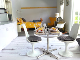 One-twelfth scale modern miniature motel room in white, grey and yellow.