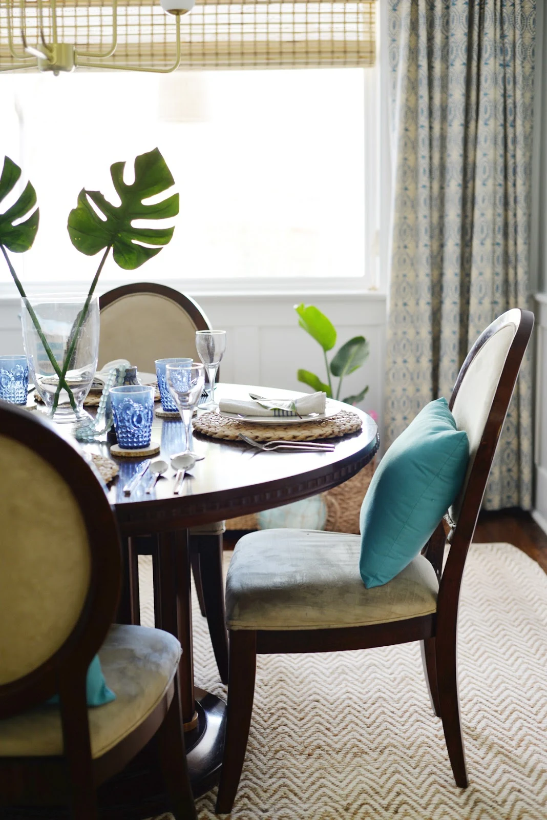 Rambling Renovators | tropical dining room, Hinkley Harlow chandelier, naga blue curtains