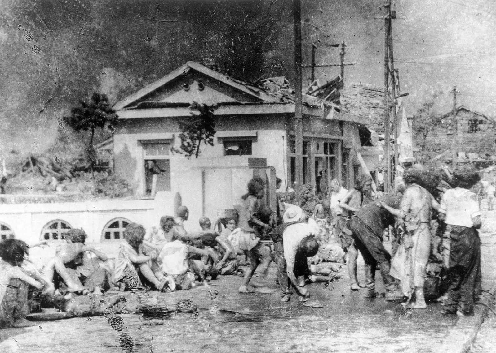 Survivors of the first atomic bomb ever used in warfare await emergency medical treatment in Hiroshima, Japan, on August 6, 1945.