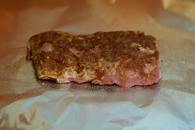 The seasoned half rack of ribs placed on the foil.