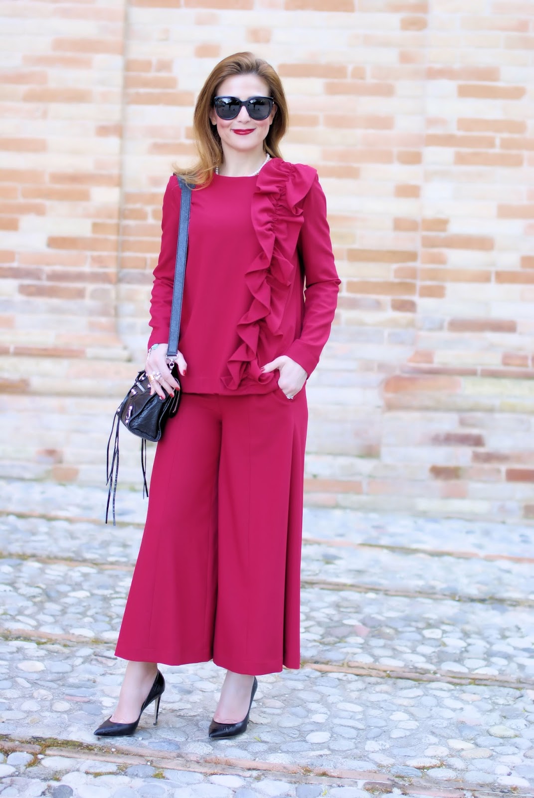 Woman in red with a ruffled blouse and wide leg cropped pants on Fashion and Cookies fashion blog, fashion blogger style