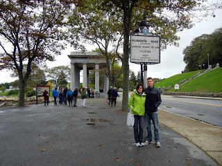 Skyler and Pattie under the Plymouth Rock sign in Plymouth, Massachusetts