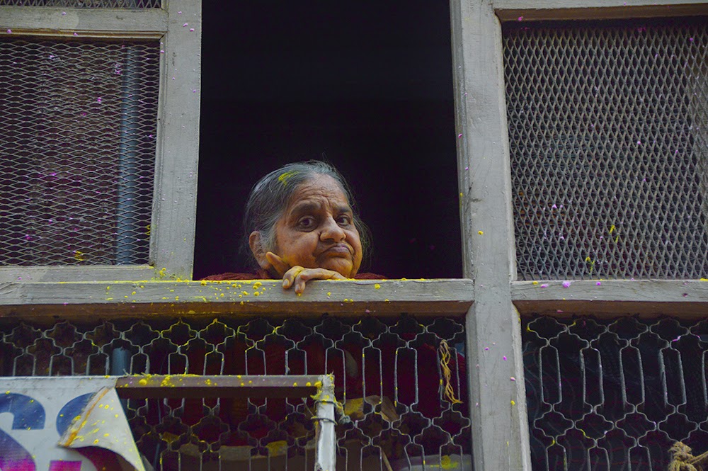 Mathura Holi celebrations procession 2015 Mathura Holi celebrations procession 2015 colors gulal red yellow old woman watching