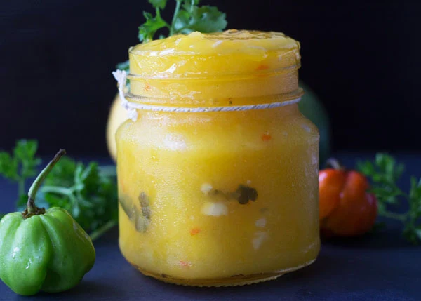 A completed serving of mango sour surrounded by peppers and other herbs.