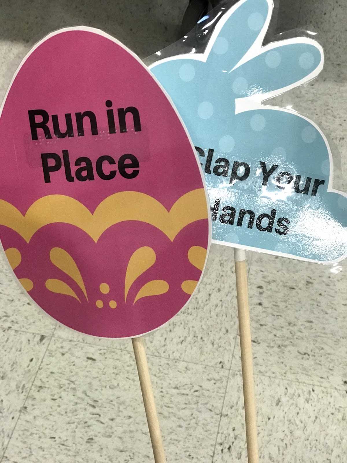 a close up of the motor activity signs "run in place" "clap your hands"