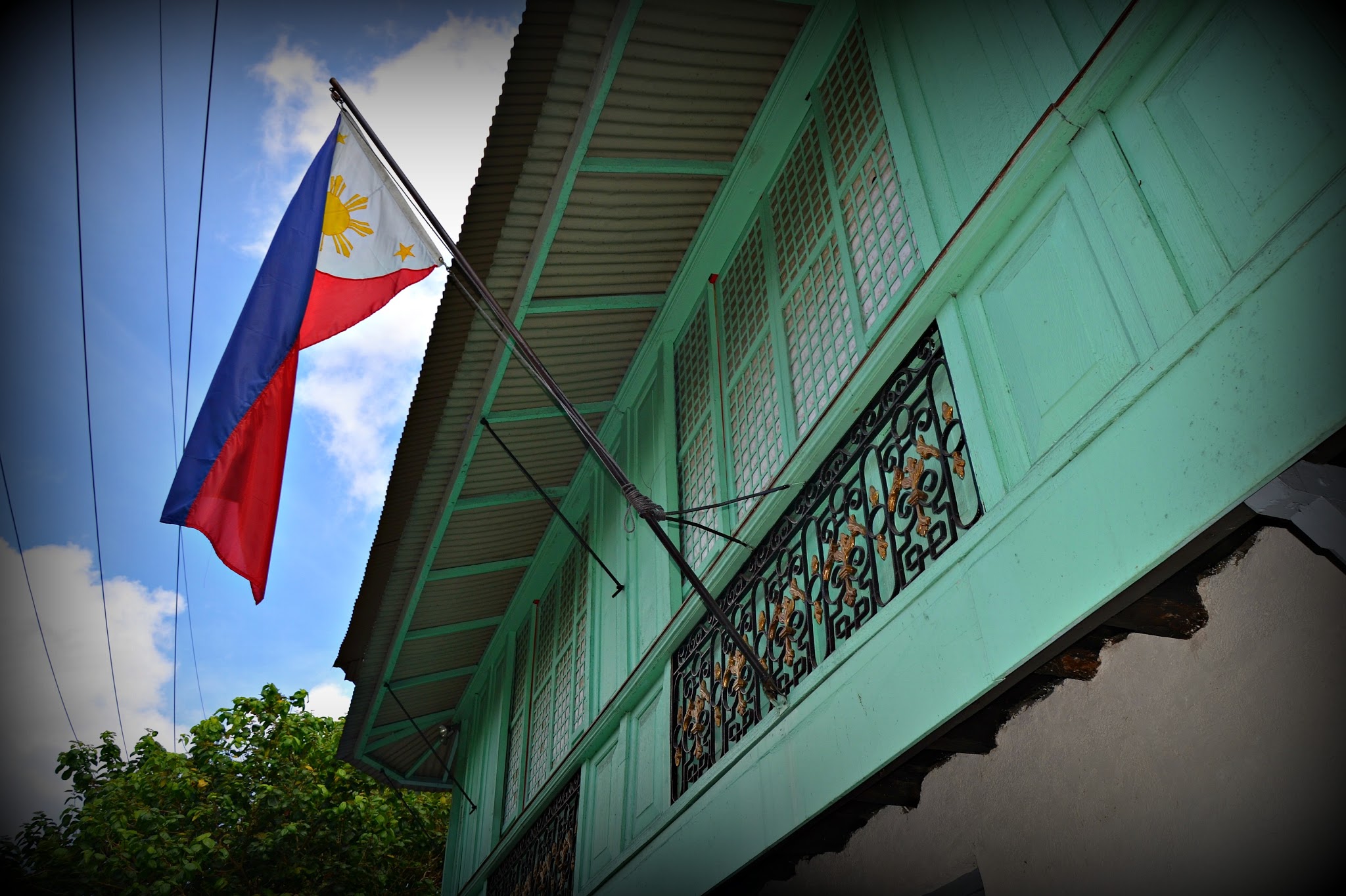 The Philippine Flag waves proudly outside the Bonifacio Trial House