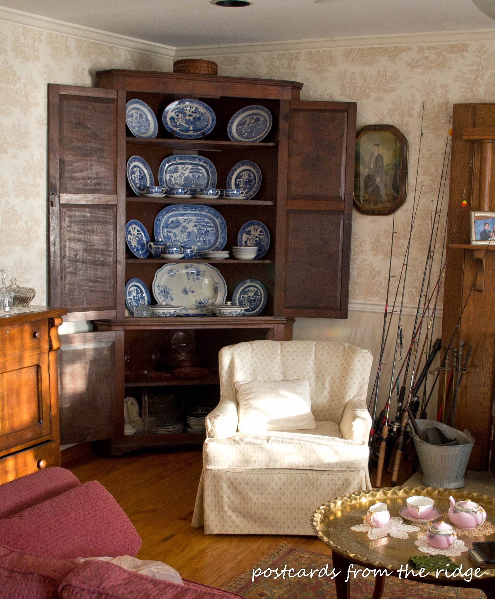 Love the blue and white dishes in the antique corner cabinet.