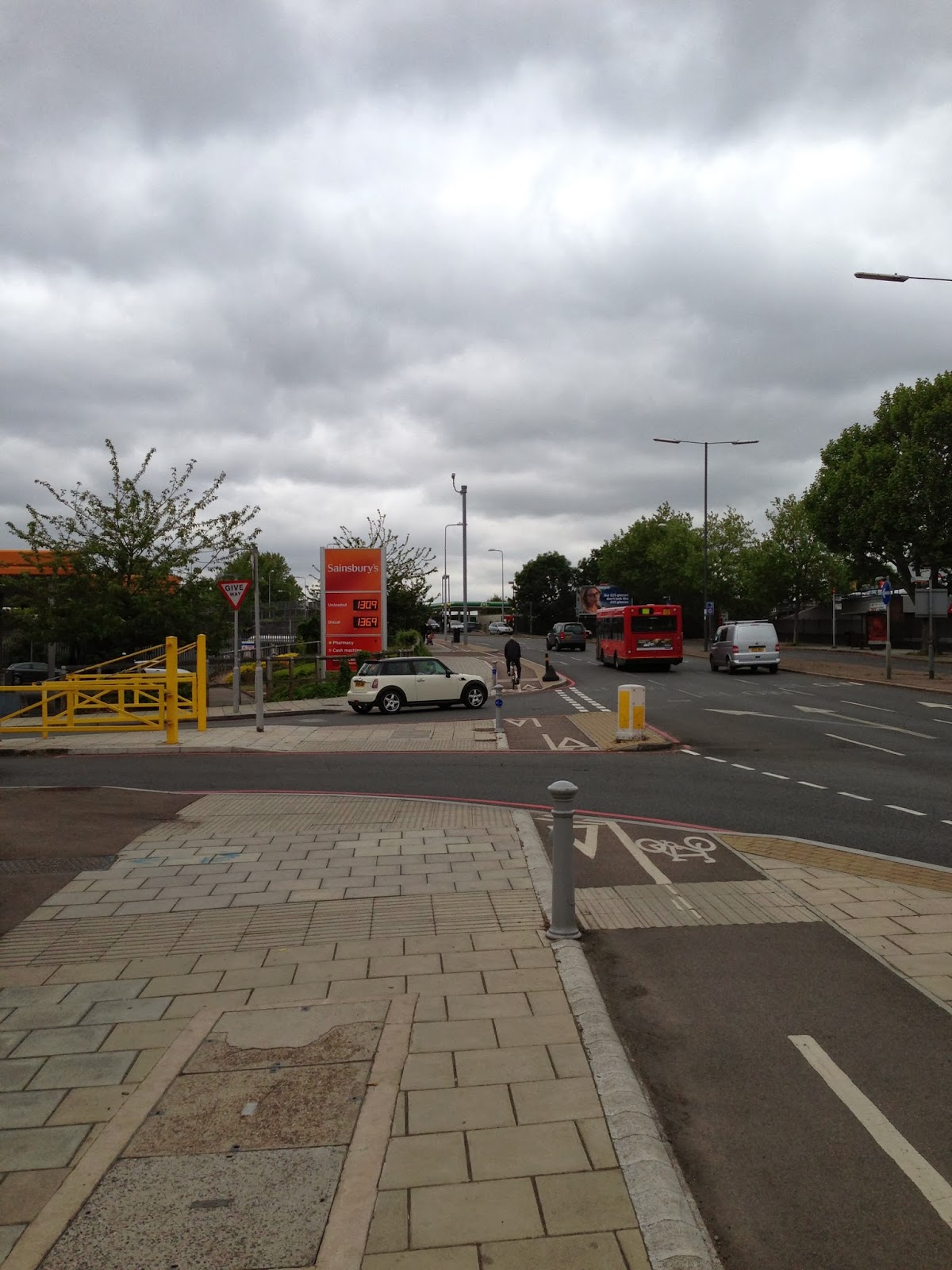 Cycle land on Lower Richmond Road (A316) interrupted by Sainsbury's entrance