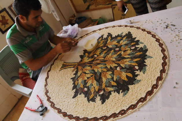 Mosaic artist creating the tree of life mosaic at Madaba, Jordan