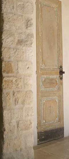 Antique Wood Paneled Door, Stone Wall via Chateau Domingue as seen on linenandlavender.net