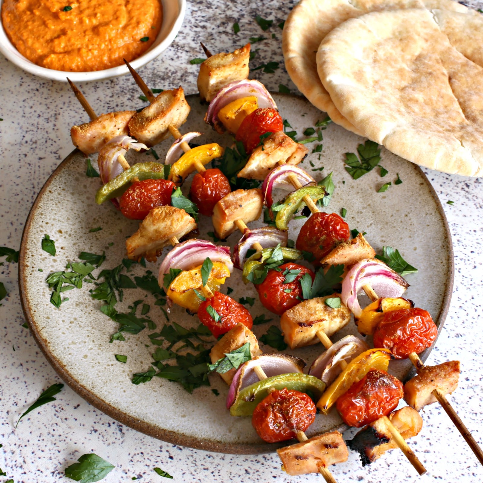 Chicken and vegetables, grilled on skewers, served with a smoky roasted red pepper sauce.