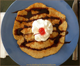 Passover Pancakes, either dressed up with chocolate and whipped cream or made "silver dollar" style with charoses, these matzo meal pancakes are delicious | Recipe developed by www.BakingInATornado.com | #Passover #breakfast