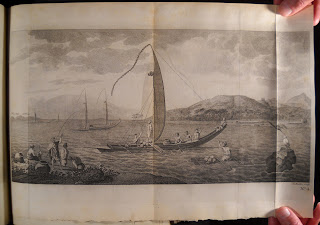 A fold-out illustration of a boat on water.