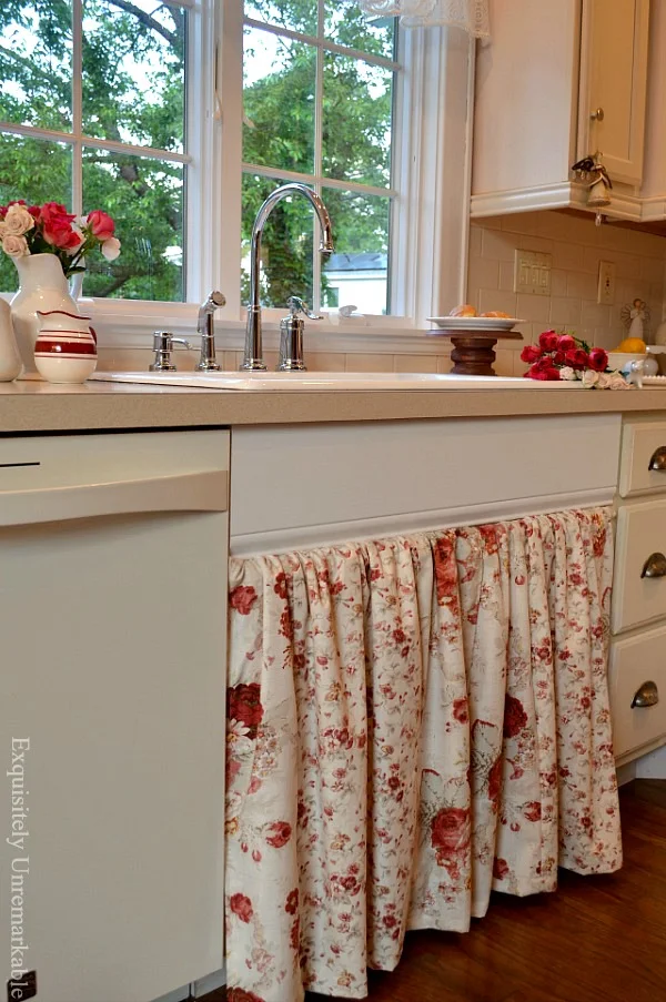 Floral sink skirt in a white cottage style kitchen