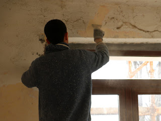 Scraping paint, and cobwebs, off the walls Scraping paint, and cobwebs, off the walls