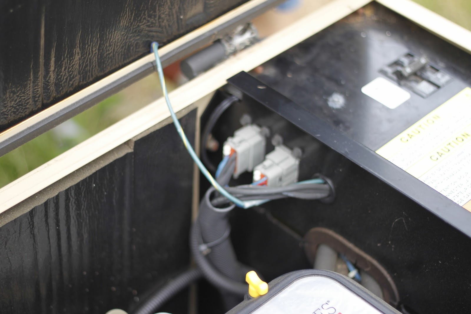 I ran the charger cable to the back of the battery bay and through a small vent to the engine compartment and then up through a notch in the sheet metal to ...