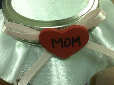 Tell mom how much you love her this Mother's Day with a jar full of chocolate hugs and kisses.  With this free printable and DIY candy jar, mom will feel like the best mom ever with you as her kid.