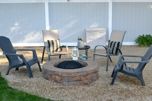 Fire pit with chairs around in pea gravel