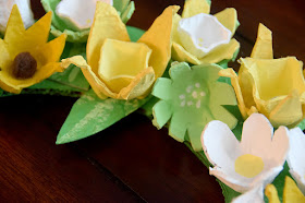 close up of yellow and white flowers made with egg cartons