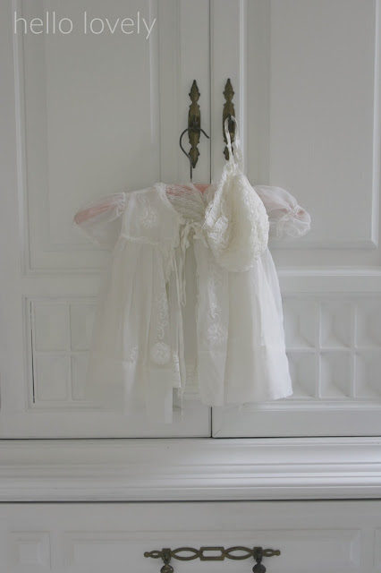 Vintage Christening gown on white armoire by Hello Lovely Studio