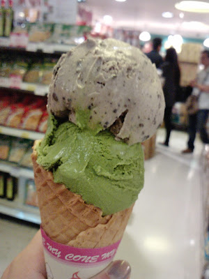 ice cream cone with scoops of Milk Top green tea ice cream and cookies & cream