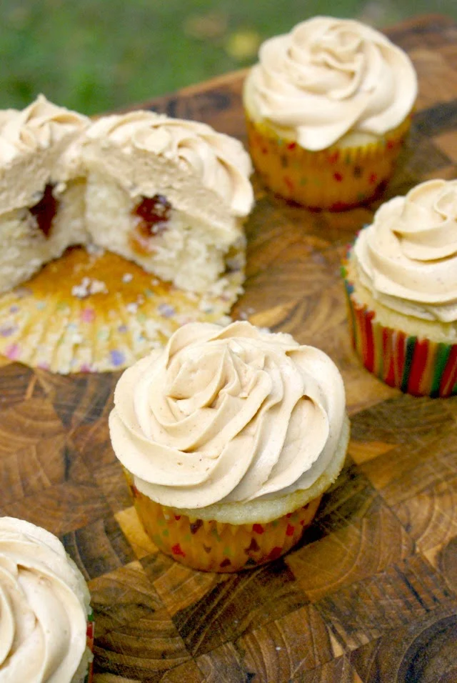 Peanut Butter and Jelly Cupcakes are moist yellow cupcakes with creamy peanut butter buttercream frosting and a sweet jelly center.