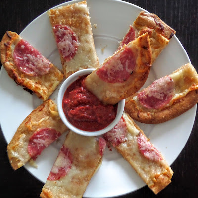 Crispy Pizza Sticks:  Crispy cheesy bread sticks with garlic and salami dipped in marinara sauce.  A great finger food for gameday or a party.