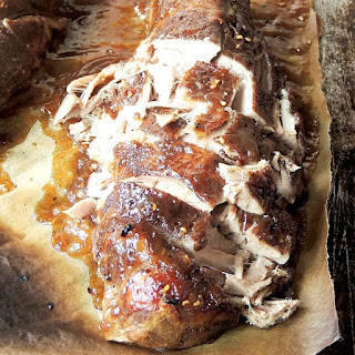 Slow Cooker Raspberry Jalapeno Pork Tenderloin is an easy to make,tender slow cooked pork tenderloin with a touch of sweet heat from a raspberry jalapeno glaze. #slowcooker #crockpot #pork #jalapeno #raspberry #easy #recipe | bobbiskozykitchen.com Slow Cooker Raspberry Jalapeno Pork Tenderloin on parchment paper.