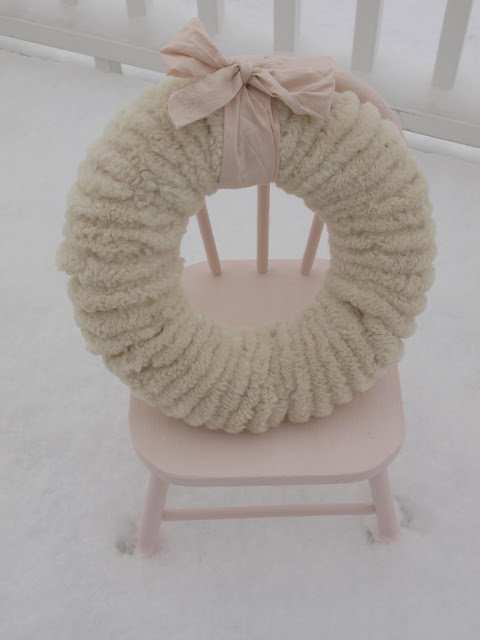 Hello Lovely Studio wooly pom pom Christmas wreath on pink chair